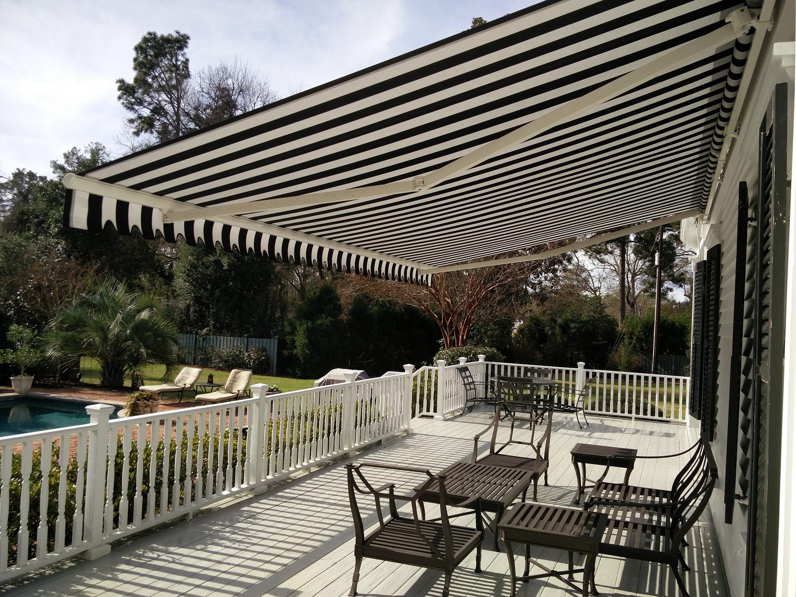 Sunesta retractable awning shading a backyard patio